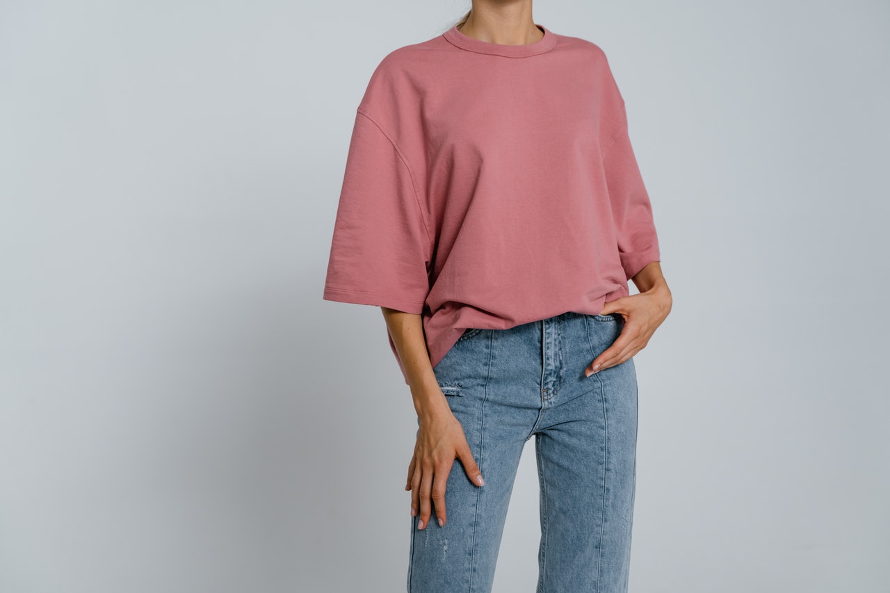 Woman is wearing an oversized pink top