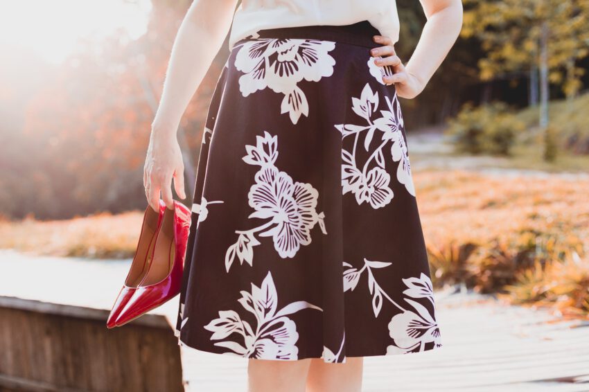 Woman is walking on the street wearing a skirt